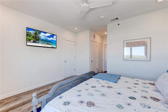 bedroom featuring a closet, hardwood / wood-style floors, and ceiling fan