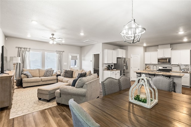 1345 Regents Park, Corpus Christi, TX 78415 - dining room with a chandelier, a ceiling fan, recessed lighting, and wood finished floors