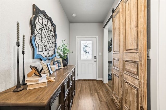 1345 Regents Park, Corpus Christi, TX 78415 - entryway with dark wood-style floors, a barn door, and baseboards