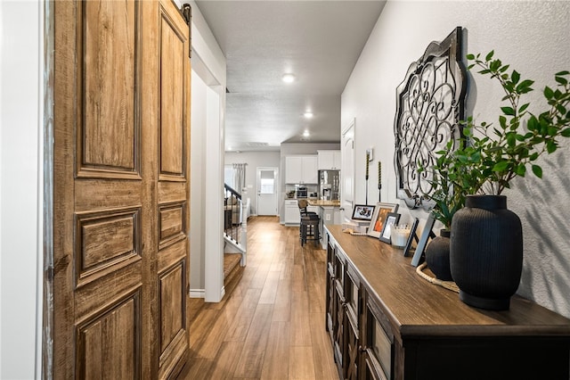 1345 Regents Park, Corpus Christi, TX 78415 - hallway with stairway, light wood-type flooring, and recessed lighting
