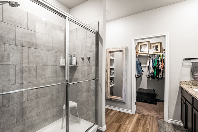 1345 Regents Park, Corpus Christi, TX 78415 - full bath featuring vanity, a shower stall, a spacious closet, wood finished floors, and baseboards