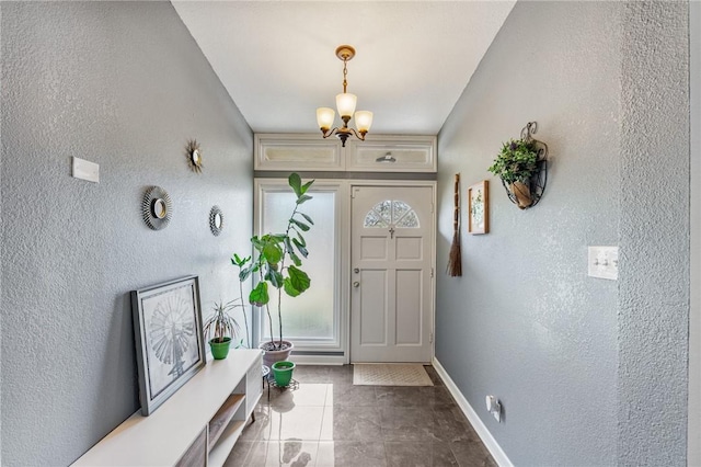 tiled foyer with a notable chandelier