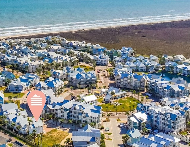 aerial view featuring a water view, a residential view, and a view of the beach