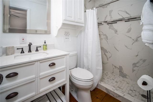 1703 Bayshores, Rockport, TX 78382 - full bathroom featuring toilet, a stall shower, vanity, and wood finished floors