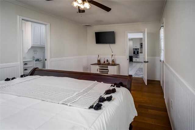 1703 Bayshores, Rockport, TX 78382 - bedroom with a wainscoted wall, wood finished floors, ornamental molding, and ceiling fan