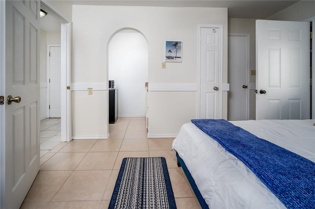 1703 Bayshores, Rockport, TX 78382 - bedroom featuring light tile patterned flooring, baseboards, and arched walkways