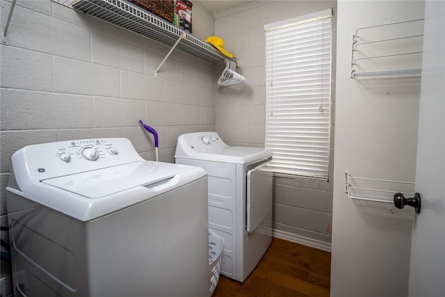 1703 Bayshores, Rockport, TX 78382 - laundry area featuring independent washer and dryer, dark wood-style flooring, and concrete block wall