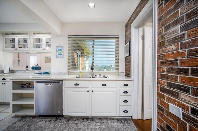 1703 Bayshores, Rockport, TX 78382 - kitchen with stainless steel dishwasher, a sink, open shelves, white cabinets, and light countertops
