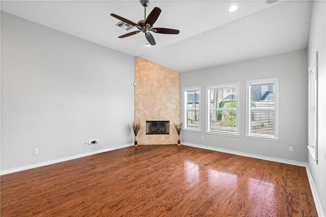 108 Black Diamond, Portland, TX 78374 - unfurnished living room featuring lofted ceiling, wood finished floors, a premium fireplace, a ceiling fan, and baseboards