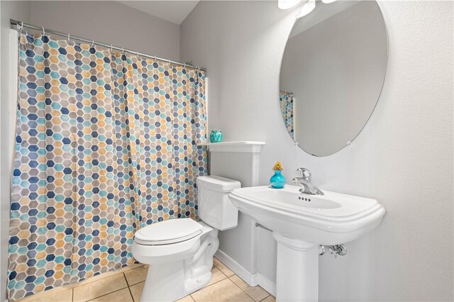 108 Black Diamond, Portland, TX 78374 - bathroom featuring tile patterned flooring, curtained shower, and toilet