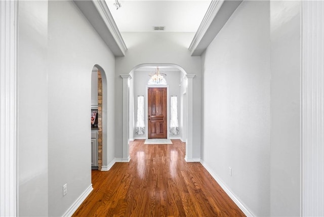 108 Black Diamond, Portland, TX 78374 - hallway with arched walkways, wood finished floors, baseboards, and ornate columns