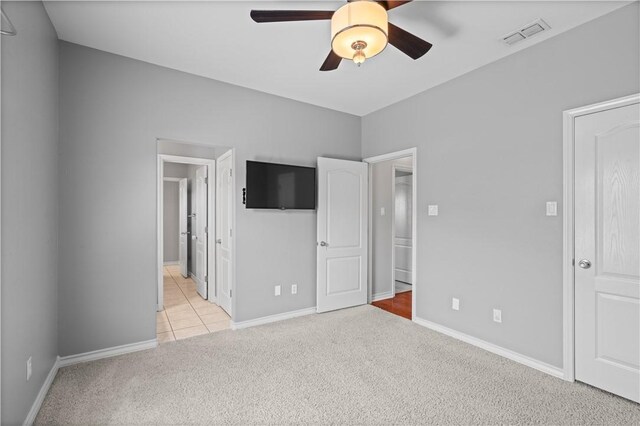 108 Black Diamond, Portland, TX 78374 - unfurnished bedroom featuring light carpet, baseboards, light tile patterned floors, and ensuite bathroom
