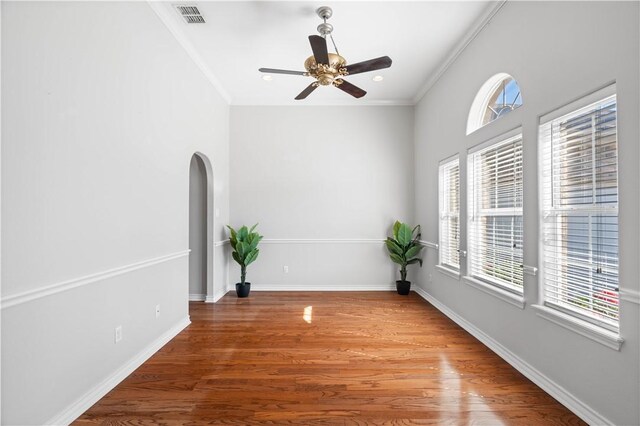 108 Black Diamond, Portland, TX 78374 - unfurnished room featuring wood finished floors, arched walkways, ornamental molding, a ceiling fan, and baseboards