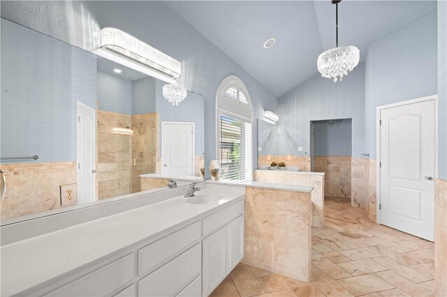 108 Black Diamond, Portland, TX 78374 - bathroom featuring a chandelier, high vaulted ceiling, tiled shower, vanity, and tile walls