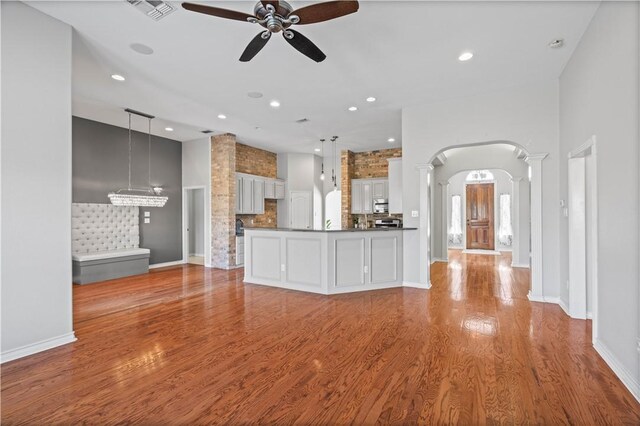 108 Black Diamond, Portland, TX 78374 - unfurnished living room with arched walkways, a ceiling fan, wood finished floors, recessed lighting, and baseboards