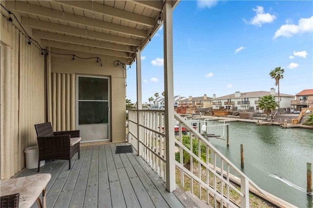 balcony featuring a deck with water view