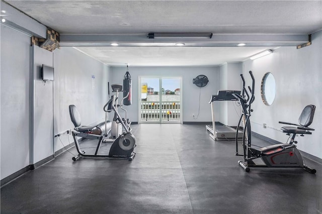 14300 S Padre Island Dr Unit 207, Corpus Christi, TX 78418 - workout room with baseboards and a textured ceiling