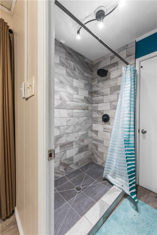 bathroom with hardwood / wood-style floors and curtained shower