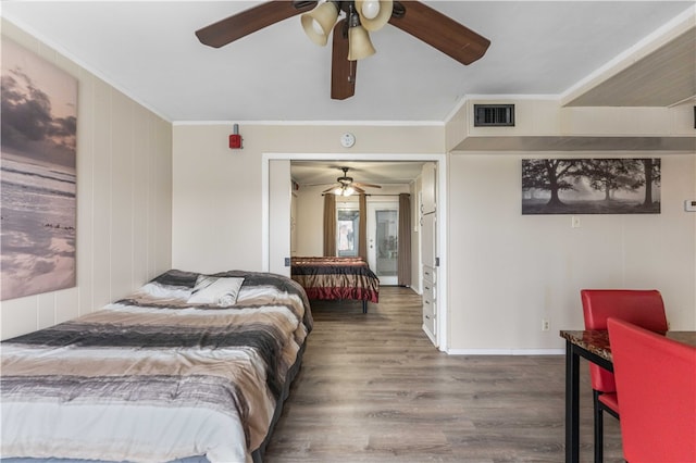 bedroom with ceiling fan, dark hardwood / wood-style floors, and crown molding