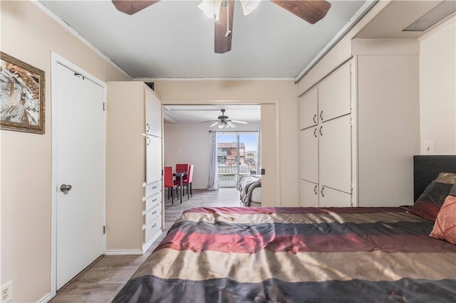 bedroom with light hardwood / wood-style floors, ceiling fan, and crown molding