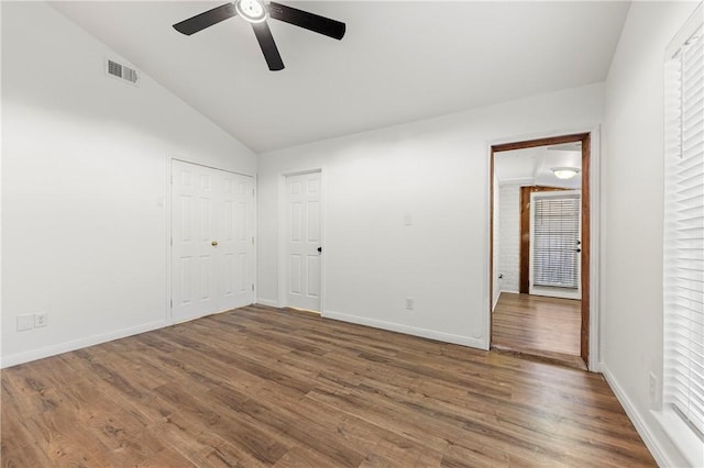 empty room featuring hardwood / wood-style floors, ceiling fan, and vaulted ceiling