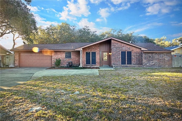 ranch-style house with a garage and a front lawn