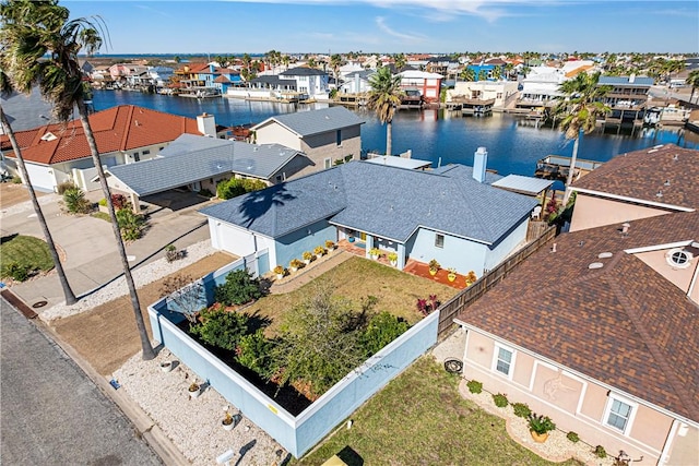 drone / aerial view with a water view and a residential view