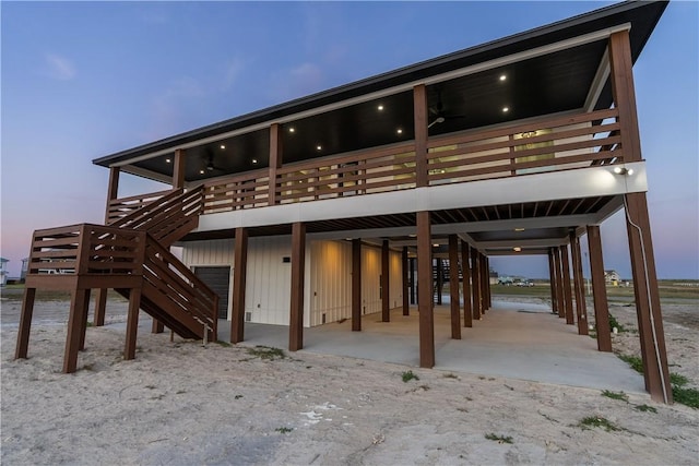 10 Westpointe Dr, Rockport, TX 78382 - back of house at dusk featuring a carport, stairway, and a deck