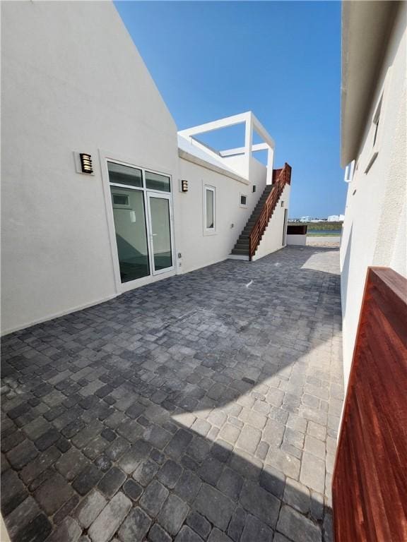 view of patio featuring stairway