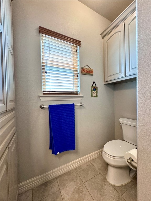 bathroom featuring toilet and tile patterned floors