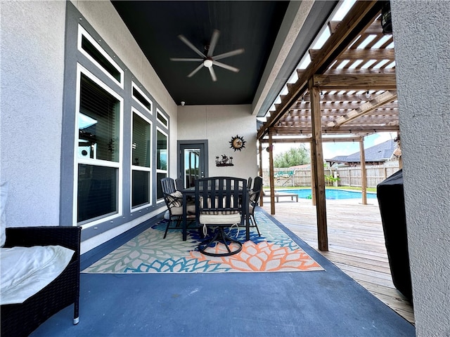 view of patio / terrace featuring a pergola, ceiling fan, and a fenced in pool