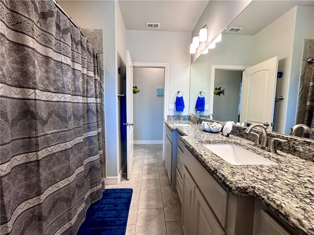 bathroom featuring curtained shower, vanity, and tile patterned floors