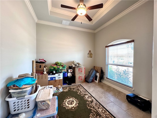 interior space featuring ceiling fan, crown molding, and a tray ceiling