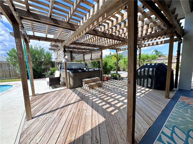 wooden deck featuring a hot tub, area for grilling, a pergola, and a patio