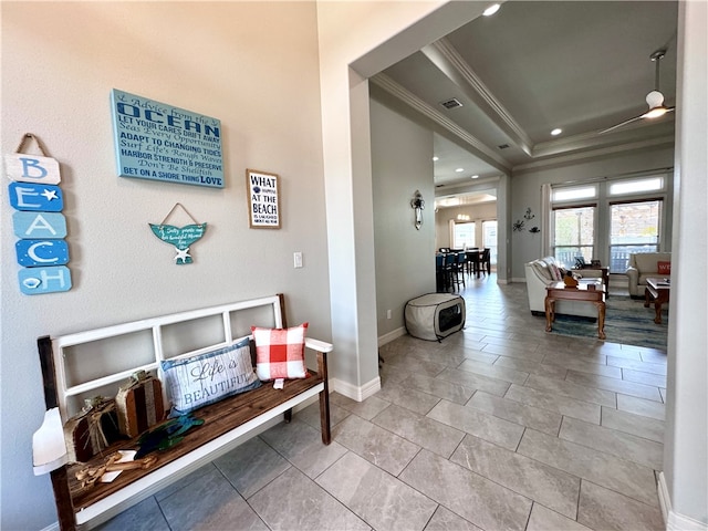 hallway featuring light tile patterned floors and ornamental molding