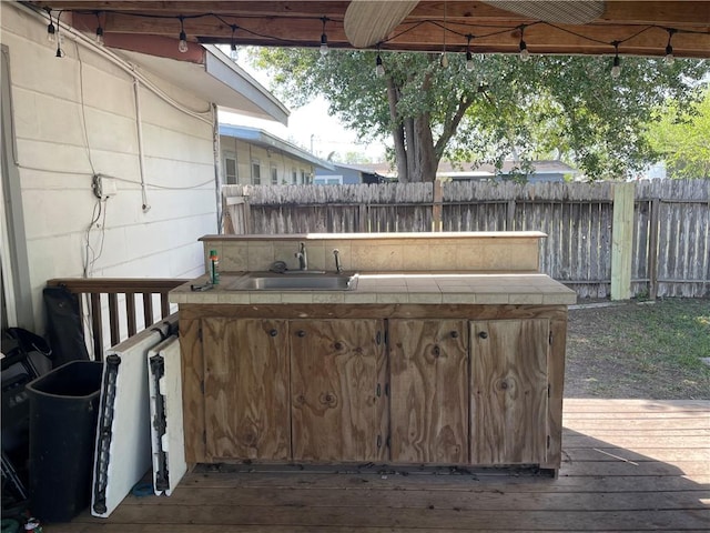 wooden terrace with fence and a sink
