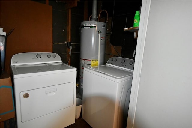 clothes washing area featuring washer and dryer, laundry area, and gas water heater