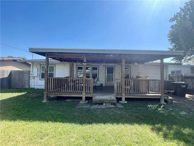 back of house featuring a deck, a yard, and fence