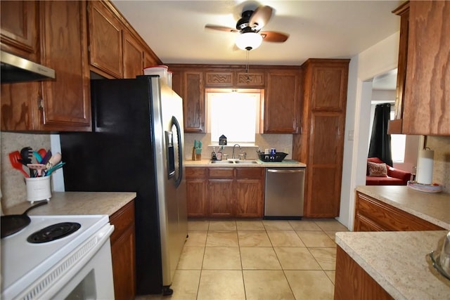 kitchen with a ceiling fan, a sink, light countertops, stainless steel dishwasher, and white electric range