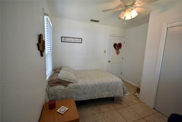 bedroom featuring light tile patterned flooring, a ceiling fan, and visible vents