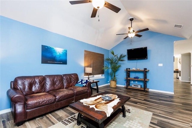 living room featuring ceiling fan, vaulted ceiling, and dark wood-type flooring