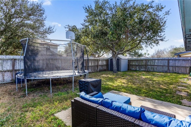 view of yard with a trampoline, a patio, and a shed