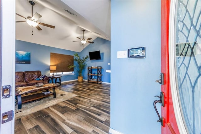 living room with ceiling fan, dark wood-type flooring, and lofted ceiling