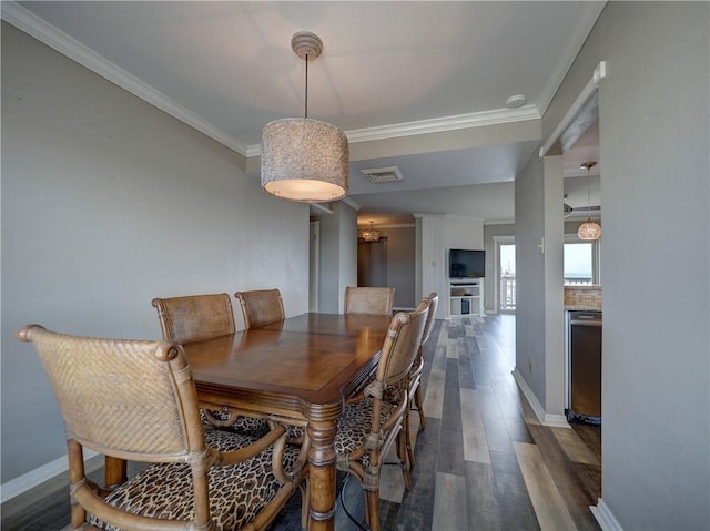 200 W Cotter Ave Unit C3, Port Aransas, TX 78373 - dining area featuring dark wood finished floors, ornamental molding, and baseboards