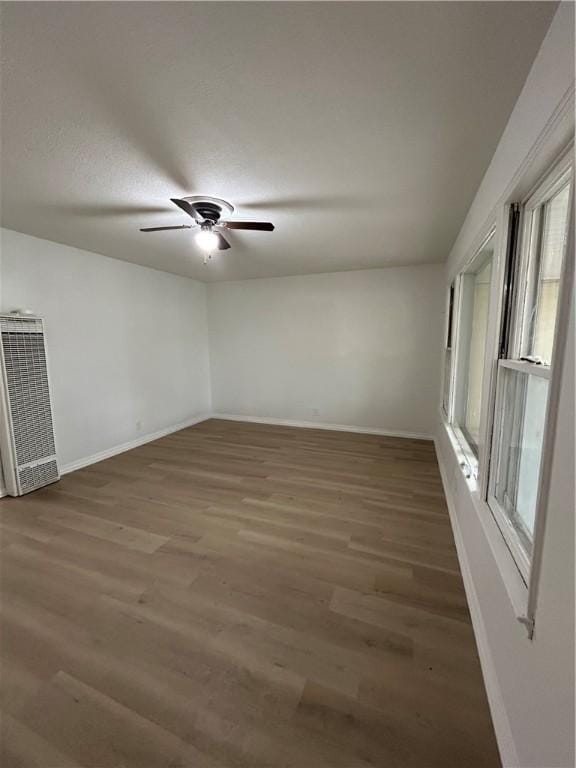 unfurnished room featuring dark hardwood / wood-style floors and ceiling fan