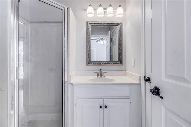 bathroom with a shower with shower door and vanity