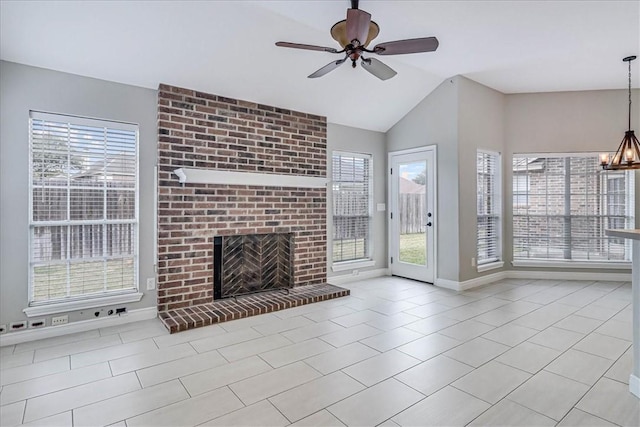 unfurnished living room featuring tile patterned flooring, ceiling fan with notable chandelier, a fireplace, baseboards, and vaulted ceiling