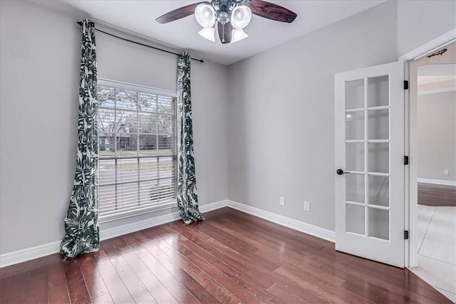 empty room featuring baseboards, ceiling fan, and hardwood / wood-style floors