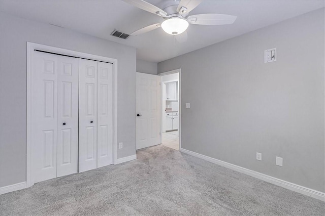 unfurnished bedroom with visible vents, baseboards, ceiling fan, carpet, and a closet