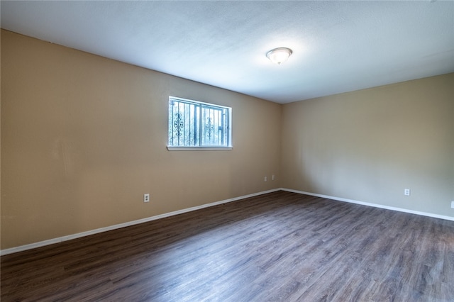 unfurnished room featuring dark hardwood / wood-style floors